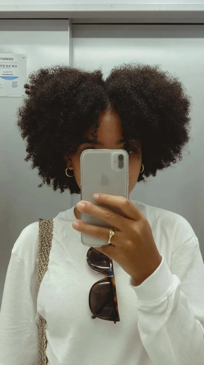 A woman with beautiful, healthy 4C hair showcasing growth and vitality.