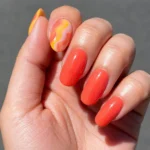 Colorful Pucci nails showcasing vibrant swirls and geometric patterns.