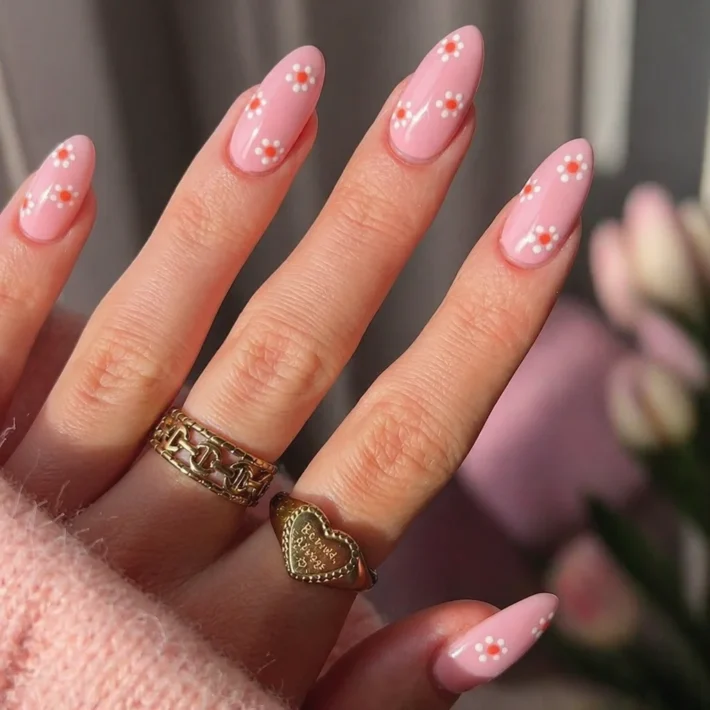 Close-up of trendy spring nail designs featuring pastels and floral art for 2026.
