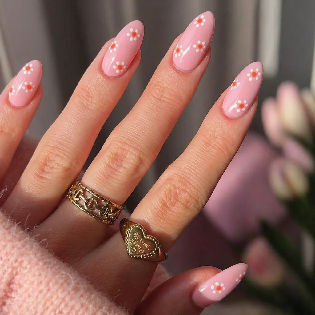 Close-up of trendy spring nail designs featuring pastels and floral art for 2026.