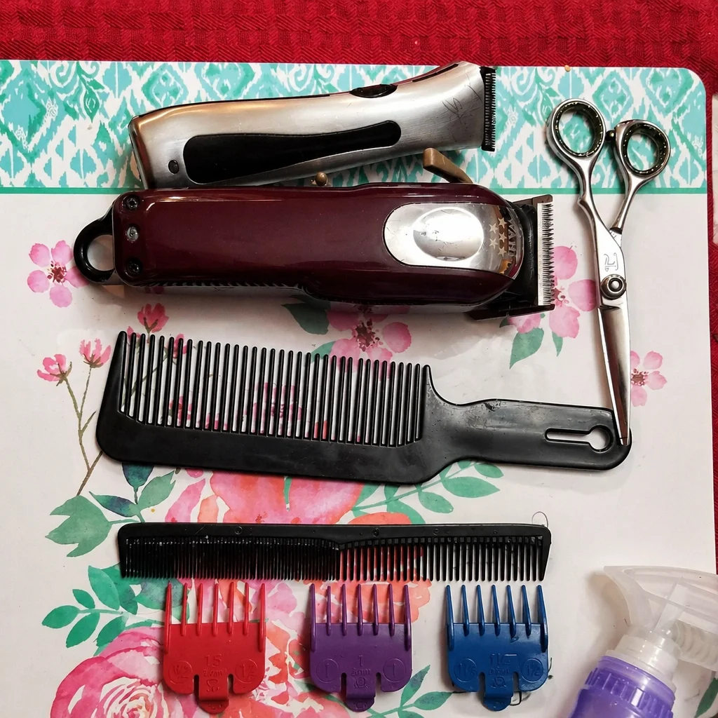 Professional hairstylist demonstrating a blended men's hair cut technique.