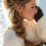 Woman showcasing stylish braided pigtails hairstyle for long hair.